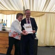 Jeannette Wheeler (left) collects the Centre of the Year award from the chief executive of the British Horse Society, James Hick. Image: UGC (user-generated content).
