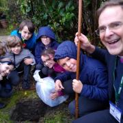 The Rt Rev Toby Howarth, Bishop of Bradford, helps children at Baildon C of E Primary bury a time capsule