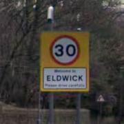 A sign welcoming people to the village of Eldwick