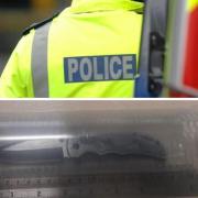 A knife seized in the police operation measured against a ruler