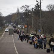 Refugees leaving their homes in Ukraine, pictured in March 2022. Pic: AP Photo/Marc Sanye