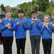 Pupils sign the word 'good'