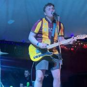 James Spencer performing at Glastonbury in his Bradford City shirt with former teacher-turned band member John Pullan playing drums