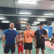 Bradford Wrestling Academy coach Brett Hawthorn, left, with, from left, national junior medal winners Zac Toothill, Logan Hall and Abdul Khan