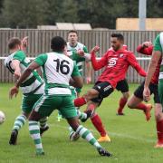 Former Campion star Mohammad Qasim (red and black) netted Brighouse's derby winner from the spot.