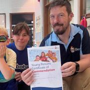 Young swimmer Alexander Dunn, left, saved his dad's life on holiday. He is pictured with his Swimbabes teacher Fiona Mellor and RLSS course tutor Garry Hume