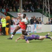 Mo Agoro (left) came back to haunt his former club, with his try just before half-time proving decisive in swinging the momentum back towards Oldham.