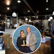 Joshua Adams Menswear owners Stephanie and Ray Norris holding their Draper Independents Award.