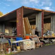 An image of the existing containers next to the listed barn, included in the planning application