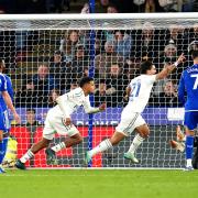 Georginio Rutter (centre) runs off to celebrate after netting Leeds' winner at Leicester.