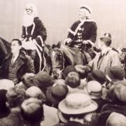 Father and Mother Christmas pass through Broadway on horseback in 1936, on their way from the city centre up to Busbys