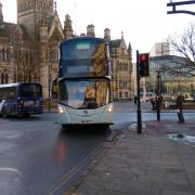 A generic photo shows a bus in Bradford city centre