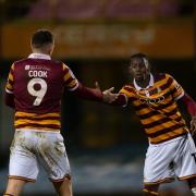 Clarke Oduor gets a handshake from Andy Cook after scoring