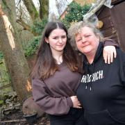 Michelle Potterton with her teenage daughter Codie, standing in front of a tree in their garden which was struck by lightning