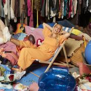 Stacey Solomon sits among a family’s possessions in the BBC show Sort Your Life Out. Picture: PA