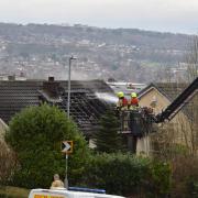 Firefighters working on a house that was alight in Hollingwood Lane, Horton Bank Top, Bradford