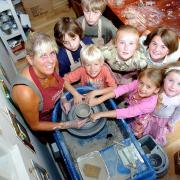 Ilkley potter Michele Raison shows youngsters how to throw a pot, 2008