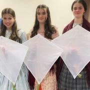 These three girls dressed up as the the Brontë sisters and flew kites over Penistone Hill in memory of victims killed in Gaza.