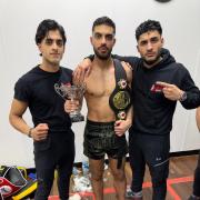 New English champion Owais Khan (centre), flanked by brother and fellow fighter Uzair Khan (left) and team-mate Sohail Khan.