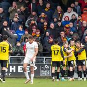 Glum faces among the City fans after Harrogate score again