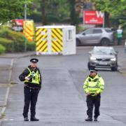 Police stand guard at the entrance to the Acorn Park Industrial Estate in Shipley where a protest took place on Wednesday