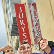 Jenny Watkinson and Victoria Collins from the University of Bradford join Jury's Inn Operations Manager, Mark Bussey, ahead of the charity abseil down the building