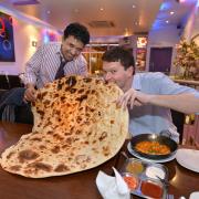 Mohammad Sadiq, owner of Omar's Balti House, with T&A  reporter Mark Stanford as he attempted the giant naan challenge