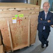 Professor Laurence Patterson with the crate in which the newly-acquired machine was delivered to the University of Bradford's Institute for Cancer Therapeutics