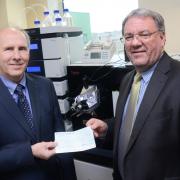 Professor Laurence Patterson, left, receives a Gannett Foundation cheque for £20,000 from T&A Editor Perry Austin-Clarke for Bradford Crocus Cancer Appeal