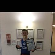 JUST CHAMPION: Callum Grace with his national medal and certificates