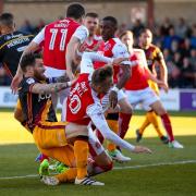 FLEET FOOTED: Romain Vincelot clashes with Fleetwood's David Ball during the semi-final second leg at Highbury. Pic: Simon Davies