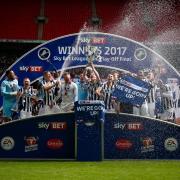 GOING UP: Millwall celebrate promotion with the League One play-off trophy – Picture: Simon Davies