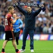 Bradford City's Billy Clarke confronted by a Millwall fans on the pitch after the League One play-off final at Wembley