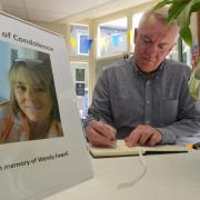 An archive picture of Otley Town Council's Councillor Ray Georgeson signing the book of condolence for Wendy Fawell
