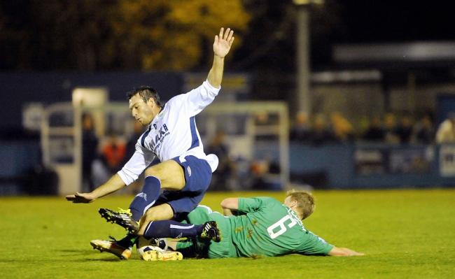 Avenue's Craig Ratcliffe slides in on Guiseley's Kevin Holsgrove during their West Riding County Cup tie