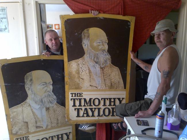 The two tin pub signs bearing the face of Keighley brewery tycoon Timothy Taylor