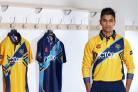 Moin Ashraf models the Yorkshire Vikings home and away shirts, which were among kit auctioned off by the Bradford bowler on Twitter