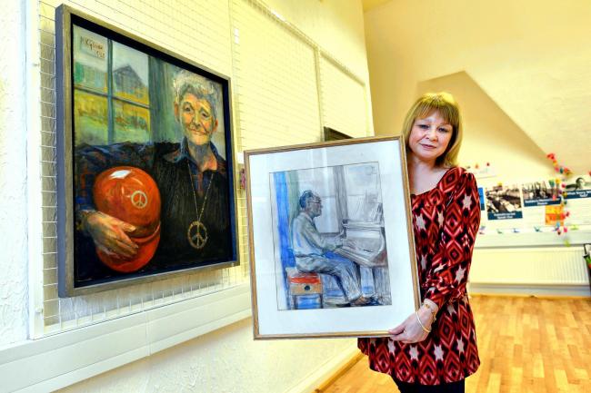 ROLE: Diane Hadwen, manager of the Peace Museum, holds a painting of music hall  legend Donald Swan