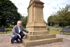 Councillor David Warburton surveys the mess left on the war memorial in Low Moor