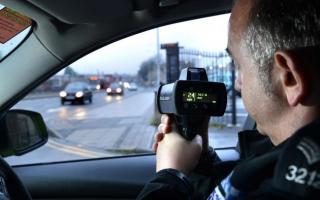 A traffic officer using a mobile speed camera
