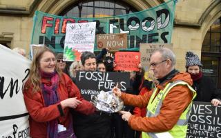 Campaigners symbolically ‘burning money’ outside Bradford City Hall in January 2020, highlighting the group's views on West Yorkshire Pension Fund’s investments in fossil fuels
