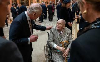 King Charles III speaks to artist David Hockney