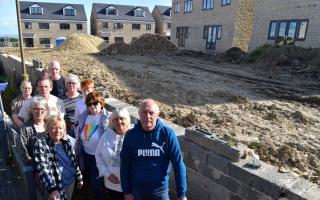 Frustrated residents by the site of the new builds during mid May 2023