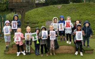 Children celebrating their nursery's Outstanding Ofsted report