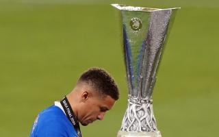 James Tavernier walks despondently past the Europa League trophy after Rangers lost last night's final on penalties. Picture: PA.