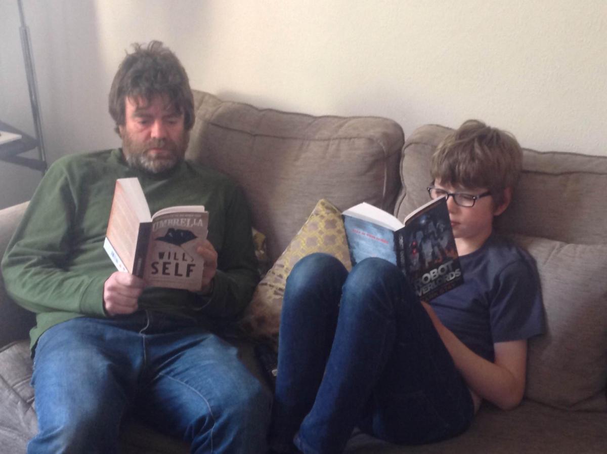 Ian Oldfield, manager of Waterstones Bradford reading with his son, Joseph, 10. “I like to read with my dad in the evenings. I was inspired to start reading Robot Overlords after a talk by the author Mark Stay at Bradford Literature Festival"