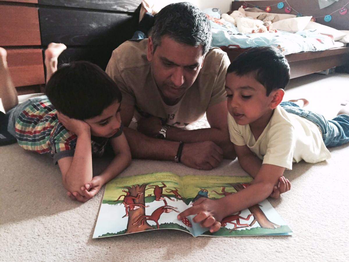 Rajan Herar reading to his twin sons, aged 5. Here we are enjoying reading one of their favourite books called Hamiltons Hats by Martin Oborne.