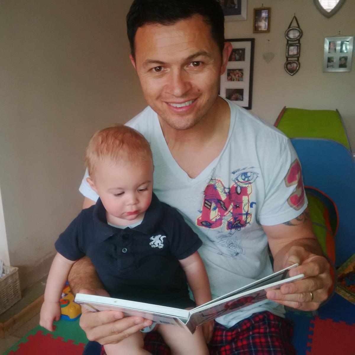 Robbie Hunter-Paul reading to his 14 month old son, Sebastian. Their favourite book is The Very Busy Spider by Eric Carle‎. He likes the book because we make all of the noises the farm yard animals would make.