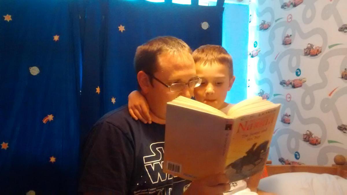 Nigel Emsley reading to his son, Alexander, aged 6. Their favourite book is The Chronicles of Narnia by CS Lewis.