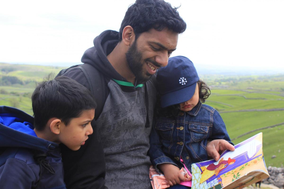 Qaiser Hussain reading with with son Isa, aged 6, and his daughter Samia, aged 3. Their favourite book is The Old Lady And The Eagle by Idreis Shah.